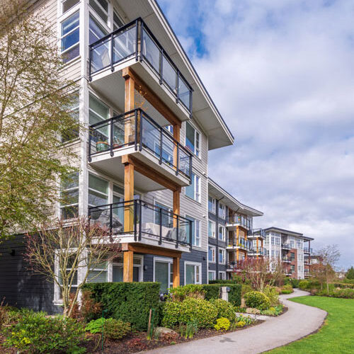 A sprawl of modern style apartment buildings within a community